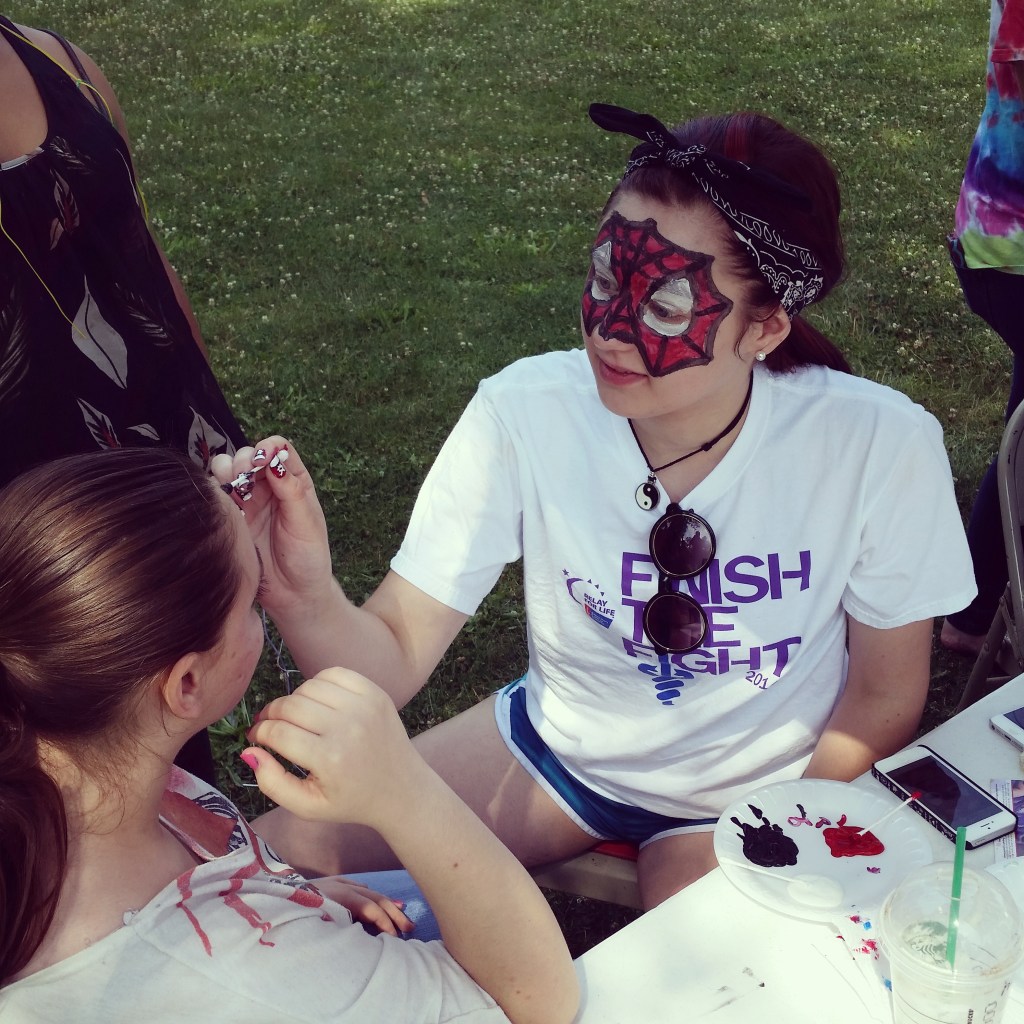 Impact 52 paints faces at the Back To School Bash